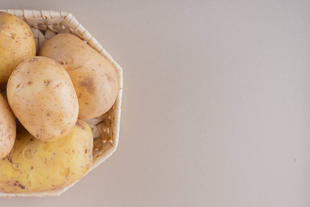 raw organic potatoes on kitchen table. - Photo, Image