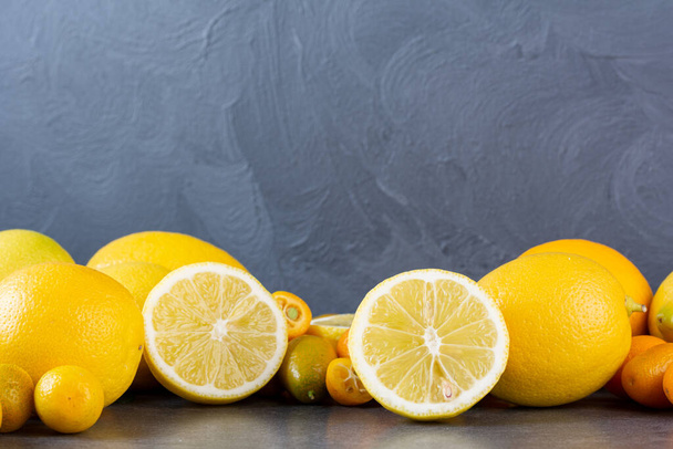 fresh yellow lemons on a grey background   - Fotografie, Obrázek