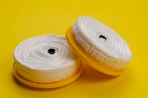 New replacement filters for Industrial respirator on yellow background. Personal respiratory protection equipment. Production safety. Close-up. Selective focus. - Photo, Image
