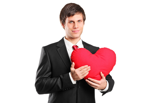 Young man holding a red heart  - Foto, afbeelding