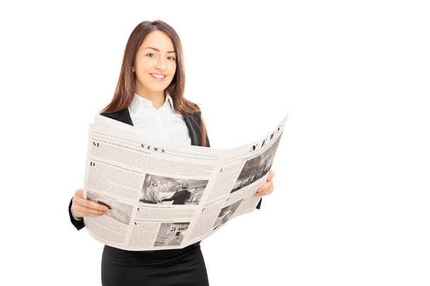Young businesswoman holding newspaper - Foto, afbeelding