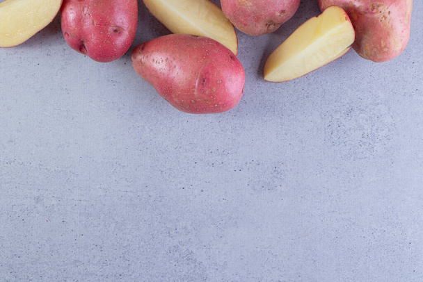 fresh organic potatoes on a gray background  - Zdjęcie, obraz