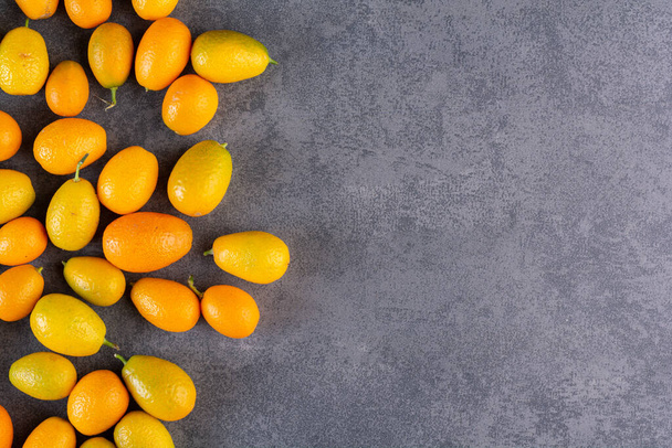 fresh kumquat fruits on kitchen table. free space for text. - Photo, image