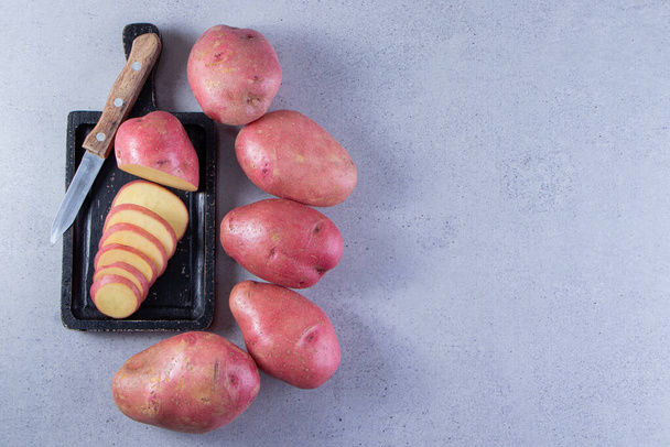 fresh organic potatoes on a gray background  - Fotoğraf, Görsel