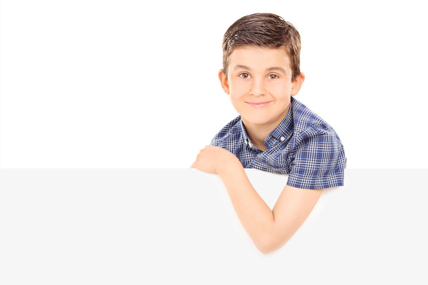 Boy posing behind blank panel - Foto, Bild
