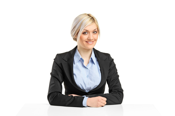 Businesswoman sitting at desk - Foto, Bild