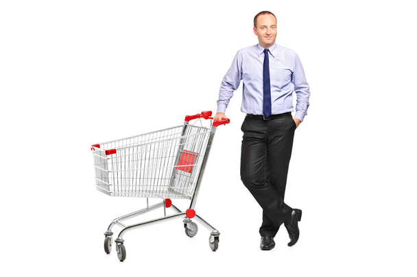 Man next to empty shopping cart - Fotó, kép
