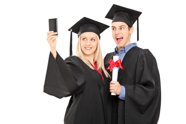 Male and female graduate taking selfie - Zdjęcie, obraz