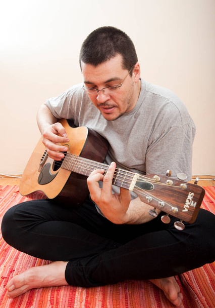 man playing guitar at home - Photo, Image