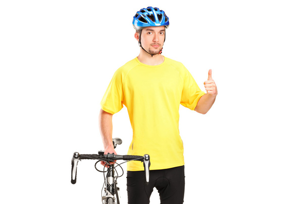 Bicyclist posing next to bicycle - Photo, image