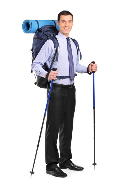 Businessman with backpack and hiking poles - Foto, Imagen
