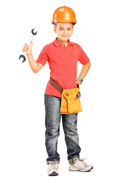 Child with helmet holding wrench - Foto, afbeelding