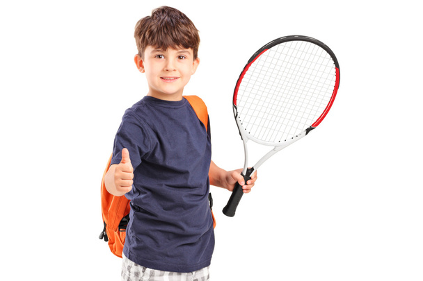 A child holding a tennis racket and giving thumb up - Foto, Bild