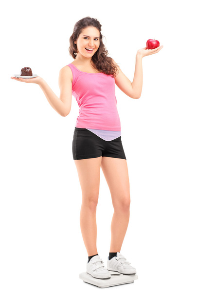 Female holding apple and cake - Φωτογραφία, εικόνα