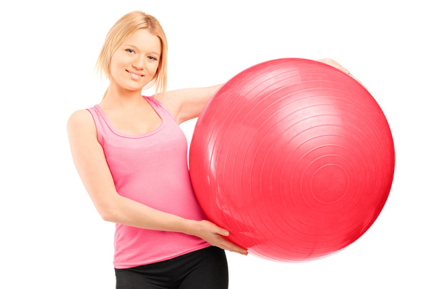 Female athlete holding pilates ball - 写真・画像