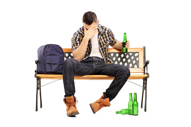 Drunk male teenager on bench - Fotó, kép