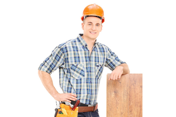 Carpenter leaning on plank - Zdjęcie, obraz
