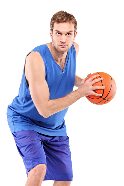 Basketball player posing with a ball - Фото, изображение