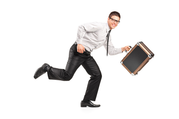 A businessman running with a briefcase - 写真・画像