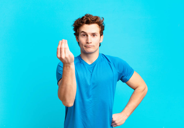 young sport boy making capice or money gesture, telling you to pay your debts! - Foto, Bild