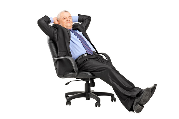 Mature businessman resting in armchair - Фото, зображення