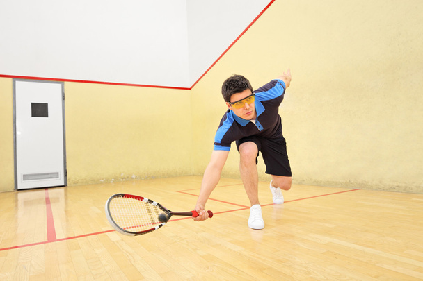 Squash player hiting ball - Fotó, kép