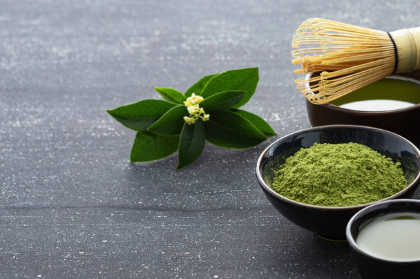 green tea leaves and cup of matcha powder, top view - Фото, изображение