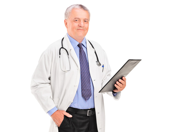 Mature doctor holding clipboard - Foto, Imagem