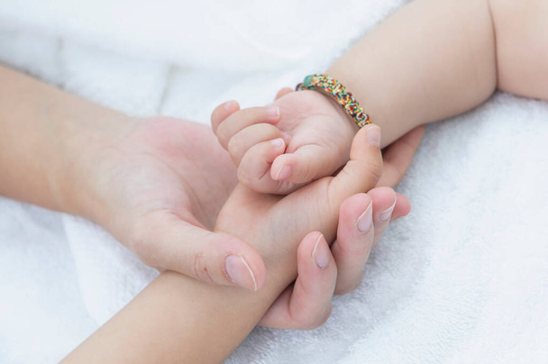 close up of a hands of a woman holding a baby's hands - Φωτογραφία, εικόνα