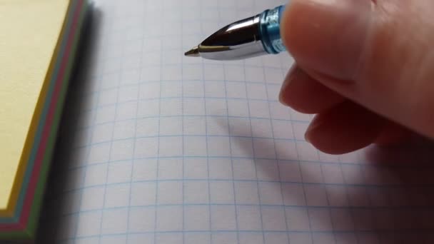 hand with pen over a blank sheet of notebook. - Footage, Video