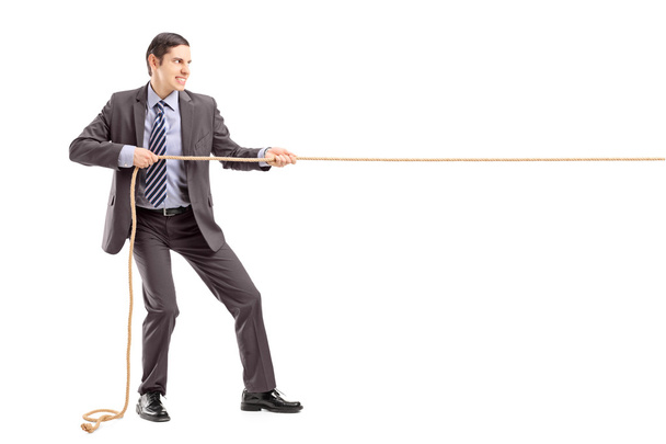 Businessman pulling rope - Fotó, kép