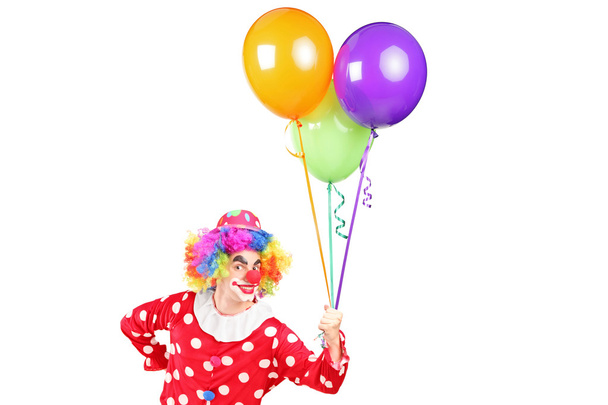 Male clown holding balloons - 写真・画像