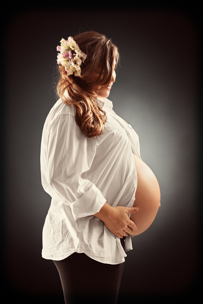Pregnant woman holding her belly - Фото, зображення