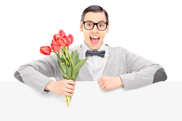 Happy male holding flowers - Valokuva, kuva