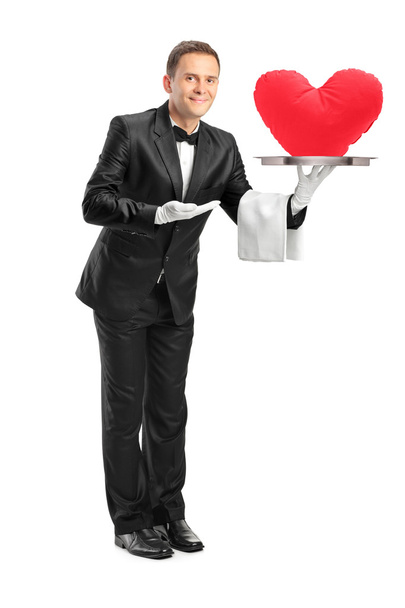 Butler holding tray with heart shape - Zdjęcie, obraz