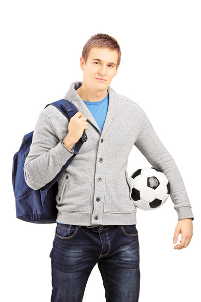 Student with school bag holding a football - Fotó, kép