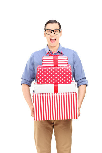 Excited young man holding presents  - Foto, Bild