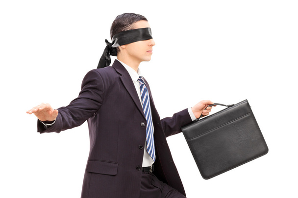 Blindfolded young businessman - 写真・画像