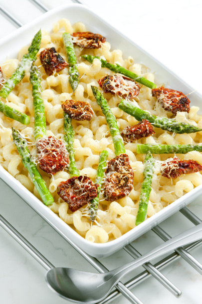 Pasta baked with dried tomatoes, asparagus and pecorino cheese - Photo, Image