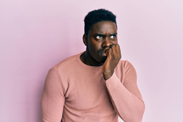 Handsome black man wearing casual clothes looking stressed and nervous with hands on mouth biting nails. anxiety problem.  - Foto, Imagen
