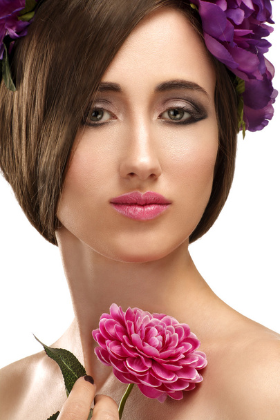 Beautiful girl with violet flowers in her hair beauty shot - Foto, Imagem