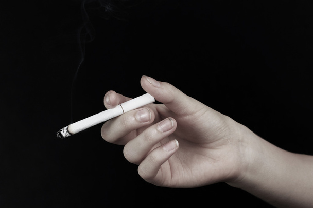 Drug abuse concept - hand holding cigarette - Foto, afbeelding