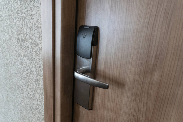 Closed door in hotel with electronic key lock. Digital security protection. - Foto, afbeelding