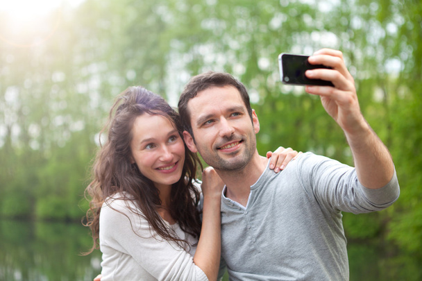 Young couple taking selfie picture at the park - Foto, Imagem