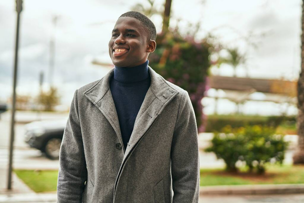 Young african american man smiling happy standing at the city - Photo, Image