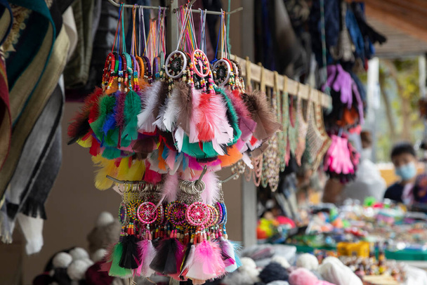 detail of several keychains with colorful dream catchers on display in a craft store - Photo, Image