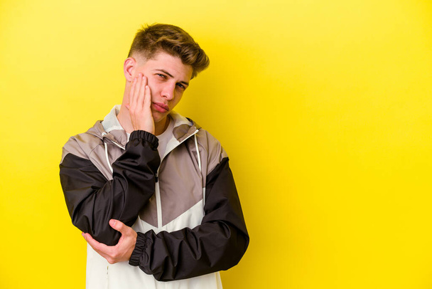 Young caucasian man isolated on yellow background who feels sad and pensive, looking at copy space. - Fotografie, Obrázek