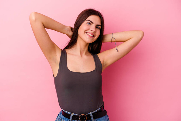 Young caucasian woman isolated on pink background stretching arms, relaxed position. - Φωτογραφία, εικόνα