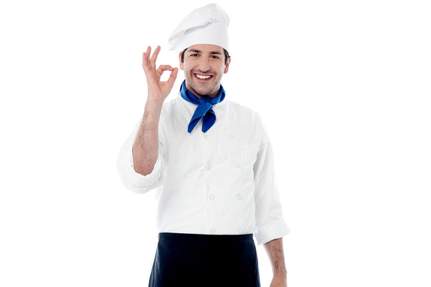 Smiling male chef showing ok hand sign - Foto, Bild