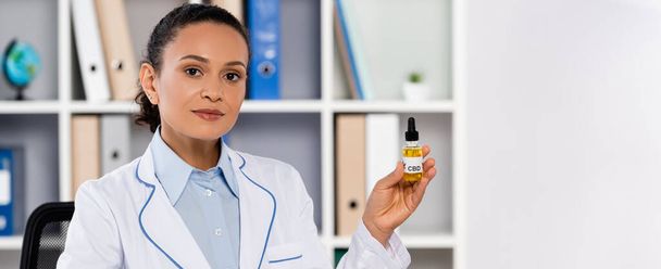 african american doctor holding bottle with legal cbd, banner - Photo, Image
